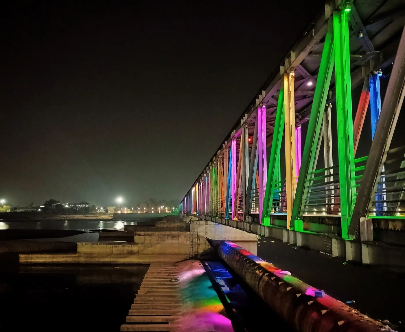 Illuminated rubber-dam bridge over the Falgu river at night in Gaya