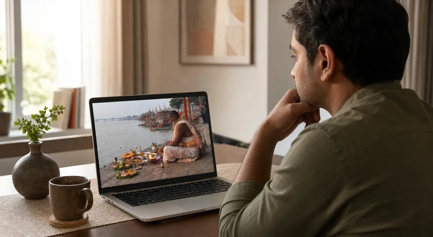 NRI devotee watching ePind Daan ritual in Gaya on a laptop